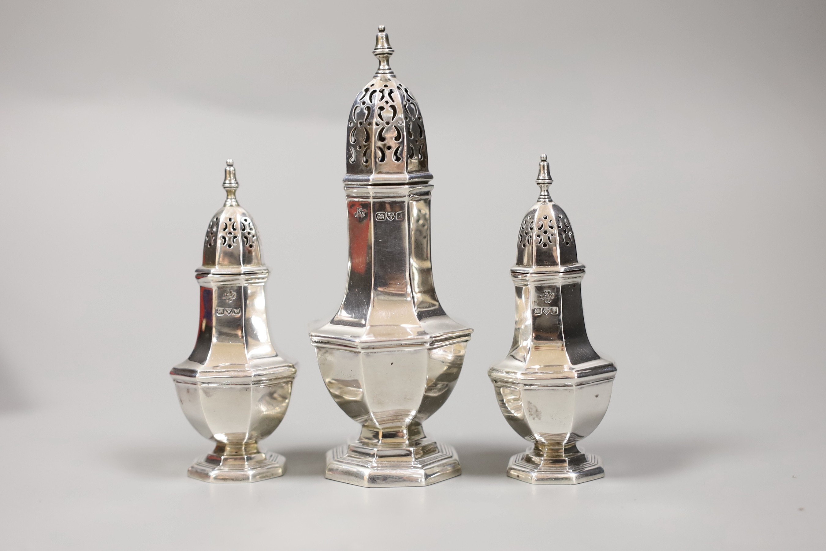 A cased Edwardian three piece pepperette and sugar caster set, by Jay, Richard Attenborough & Co, Chester 1909, caster, 12.7cm, 3.6oz.